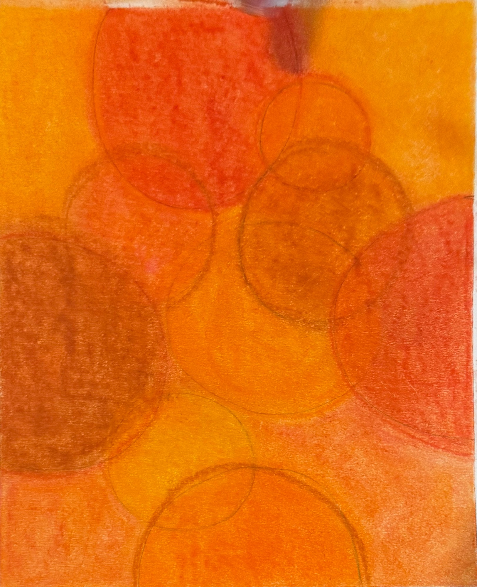 Circles emerge through layers of golden yellow, orange and rust.