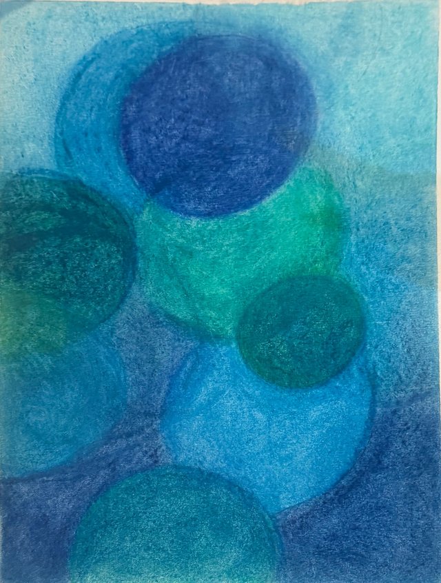 Blue and green circles drift across one another, with a dark blue disc near the top.