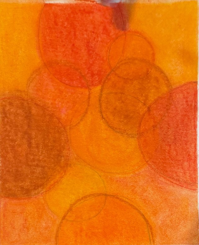 Circles emerge through layers of golden yellow, orange and rust.