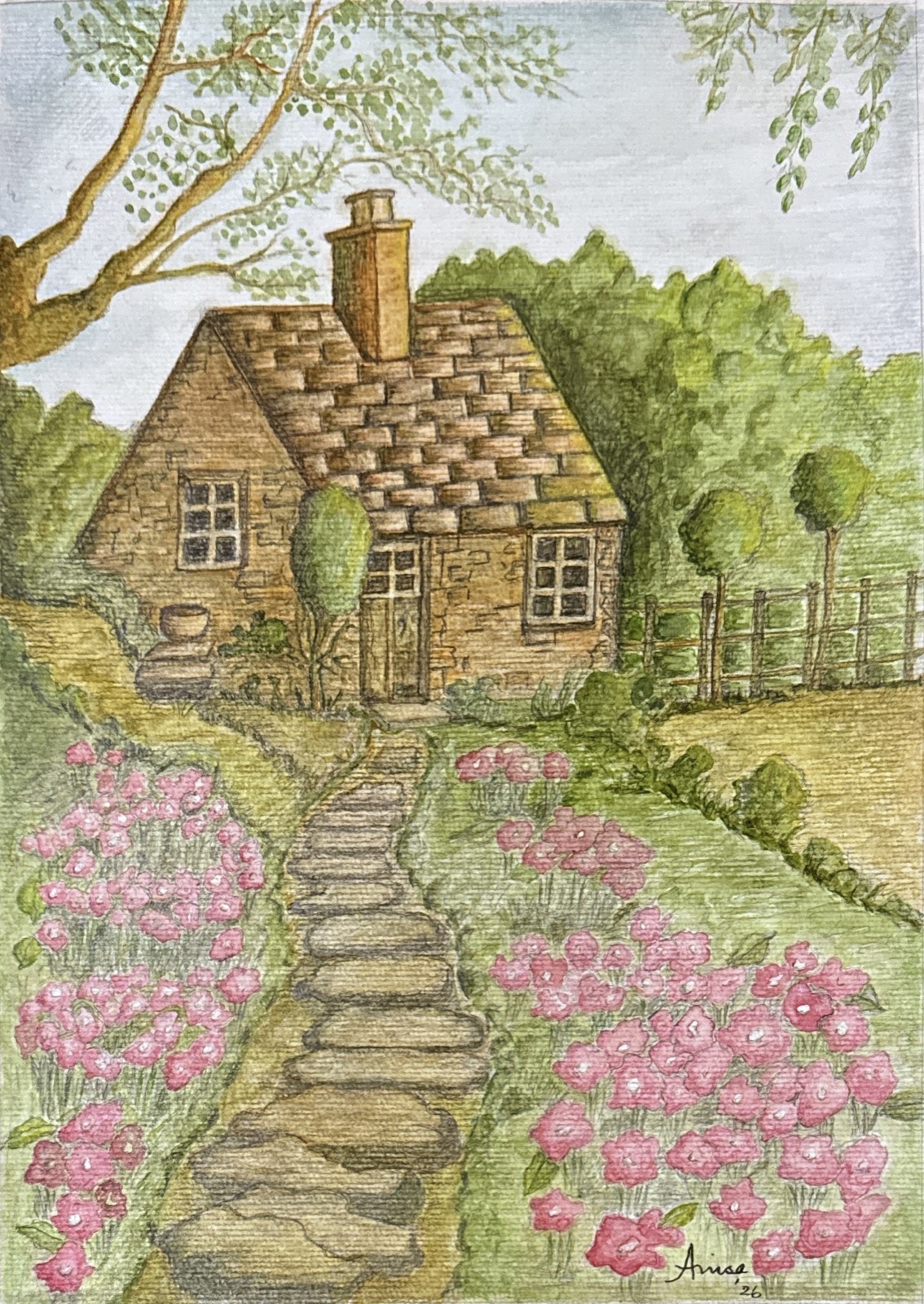 A stone path winds between beds of pink flowers to the door of a small cottage beneath leafy trees.